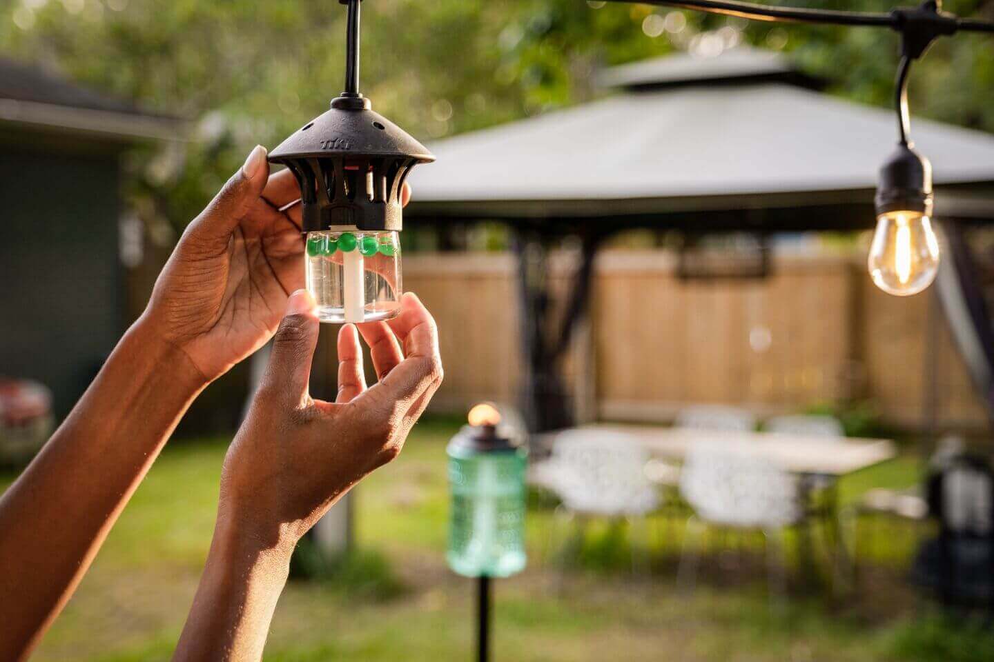 Female twisting in repellent pod for string lights