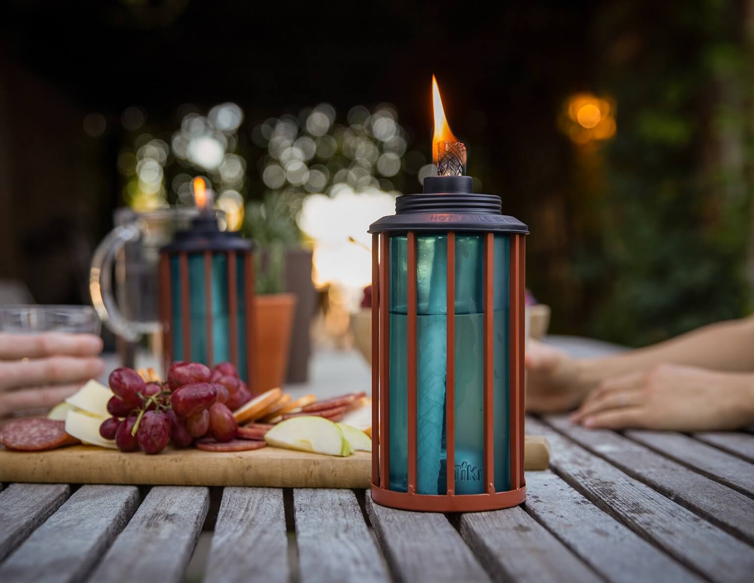 TIKI Brand table top torches on a picnic table