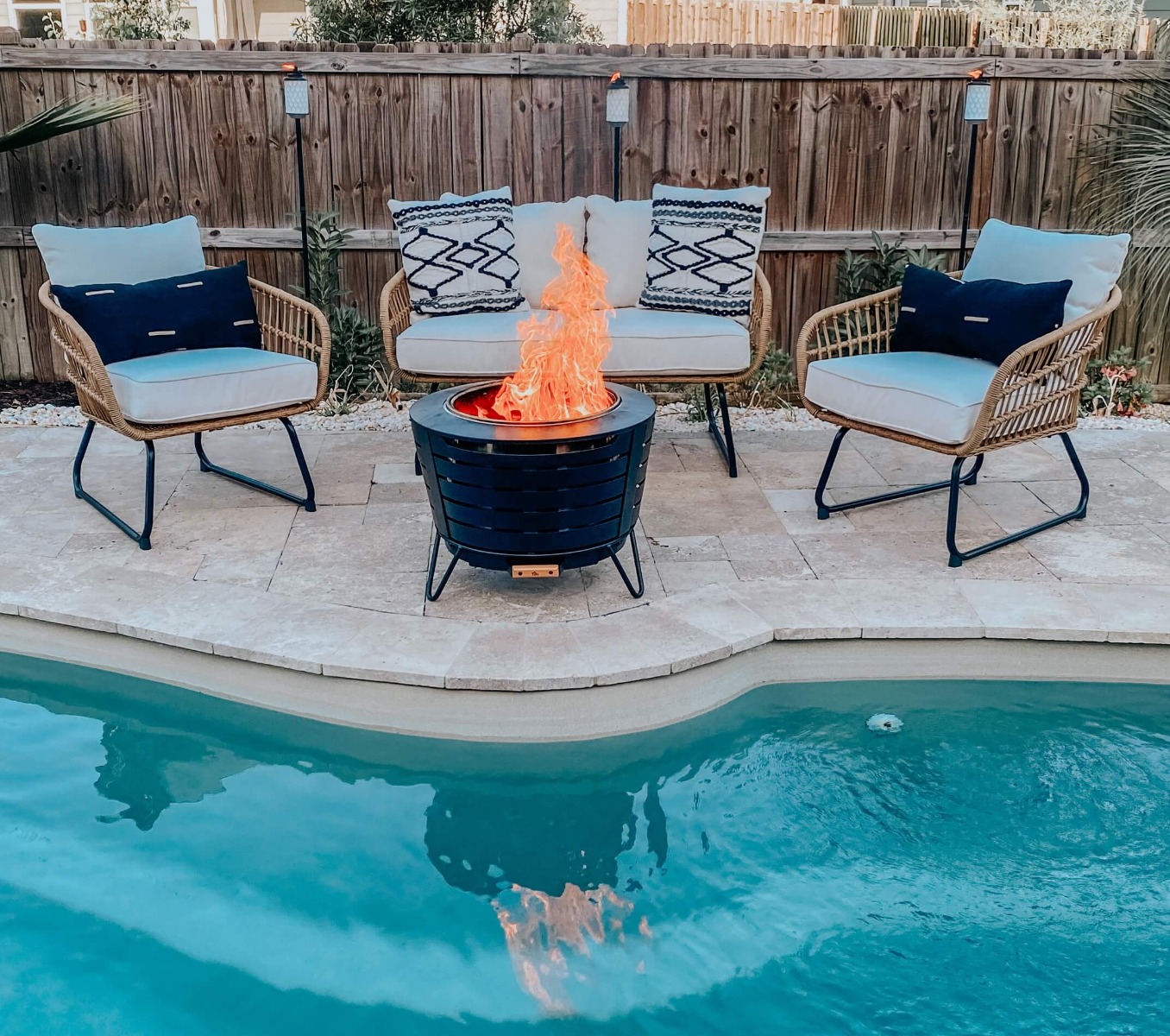 Smokeless Fire Pit with two chairs by a pool