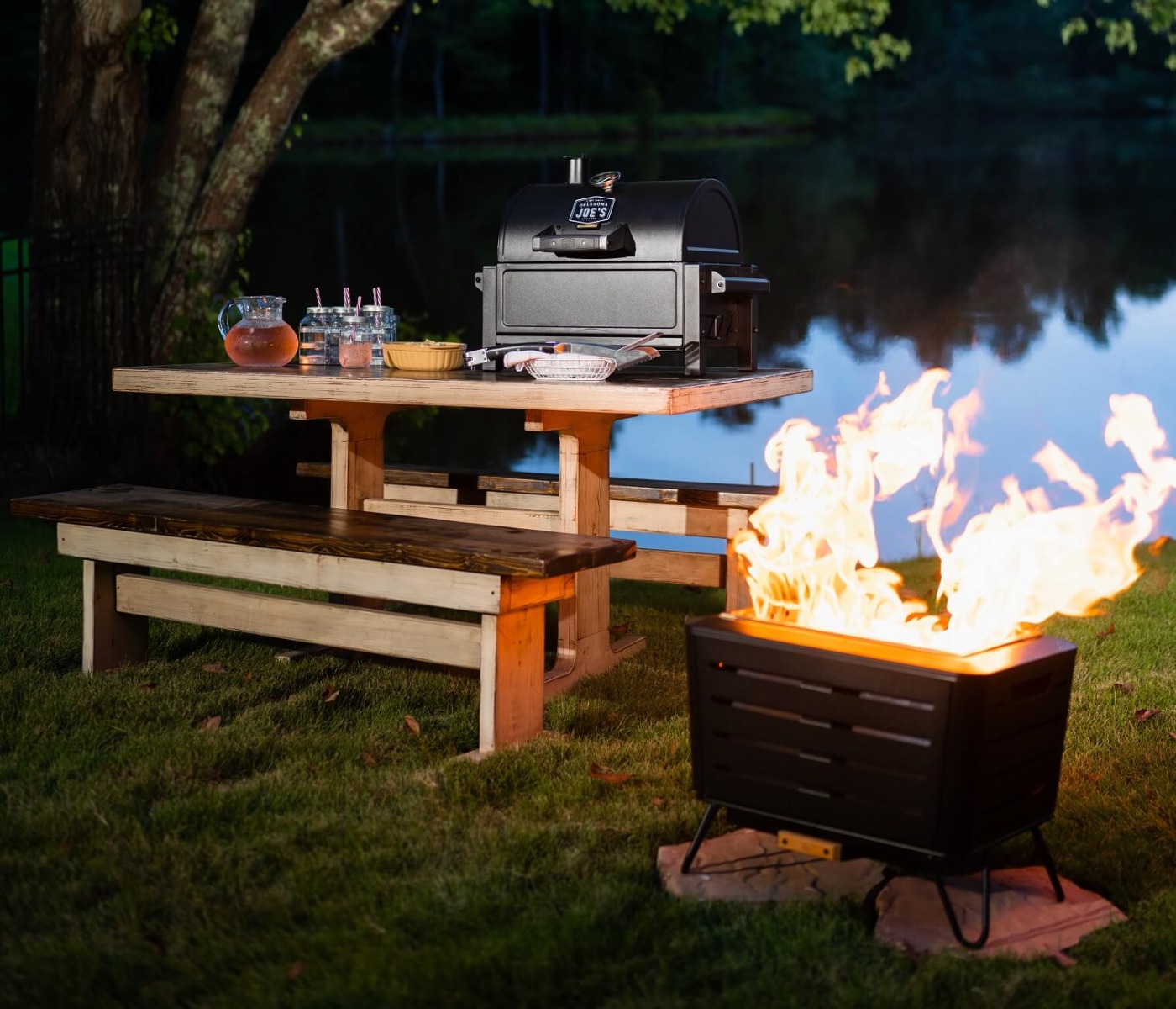 Smokeless fire pit near a lake for a camping experience with Oklahoma Joe's portable grill