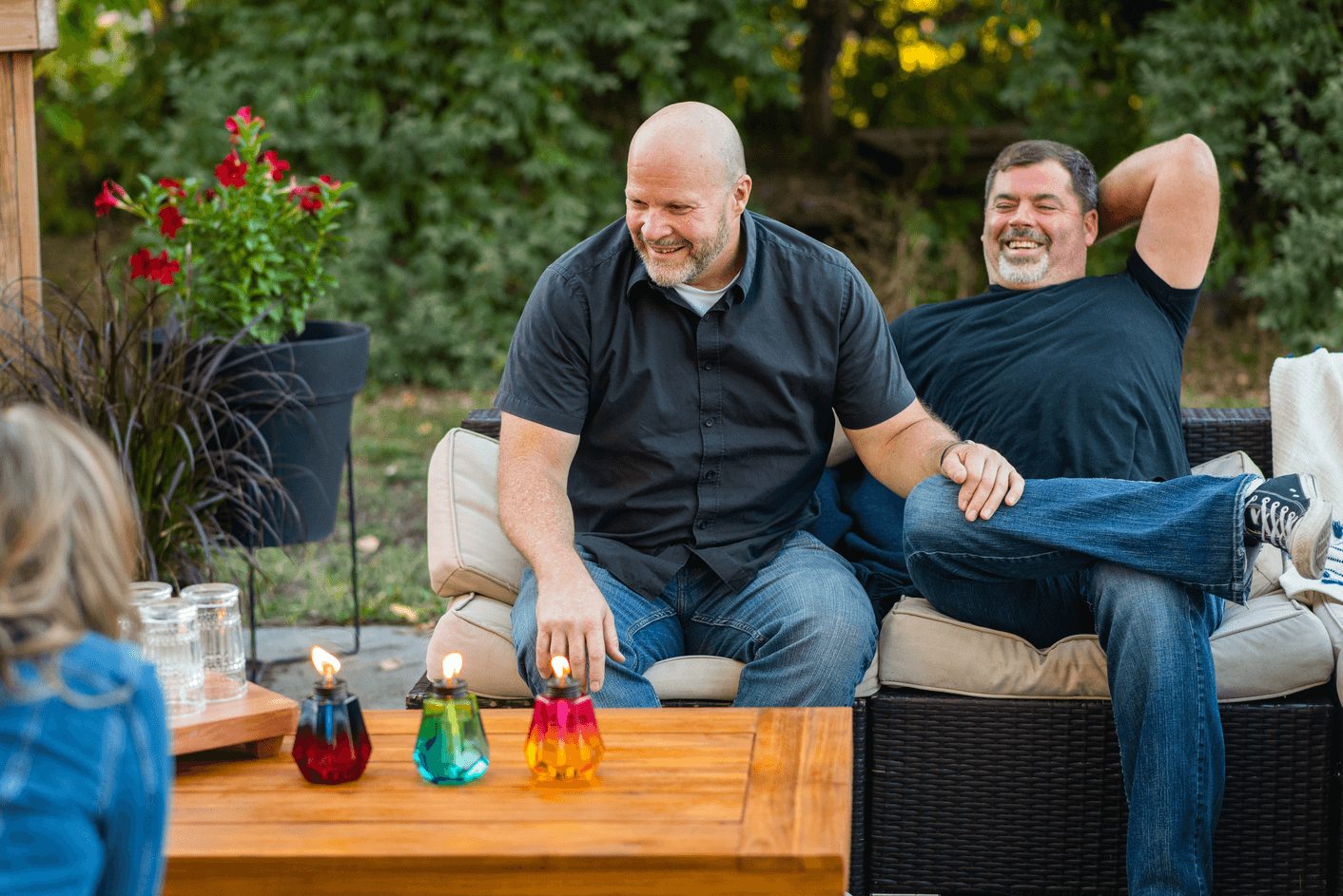 Couple enjyingn  their backyard with some TIKI Torches