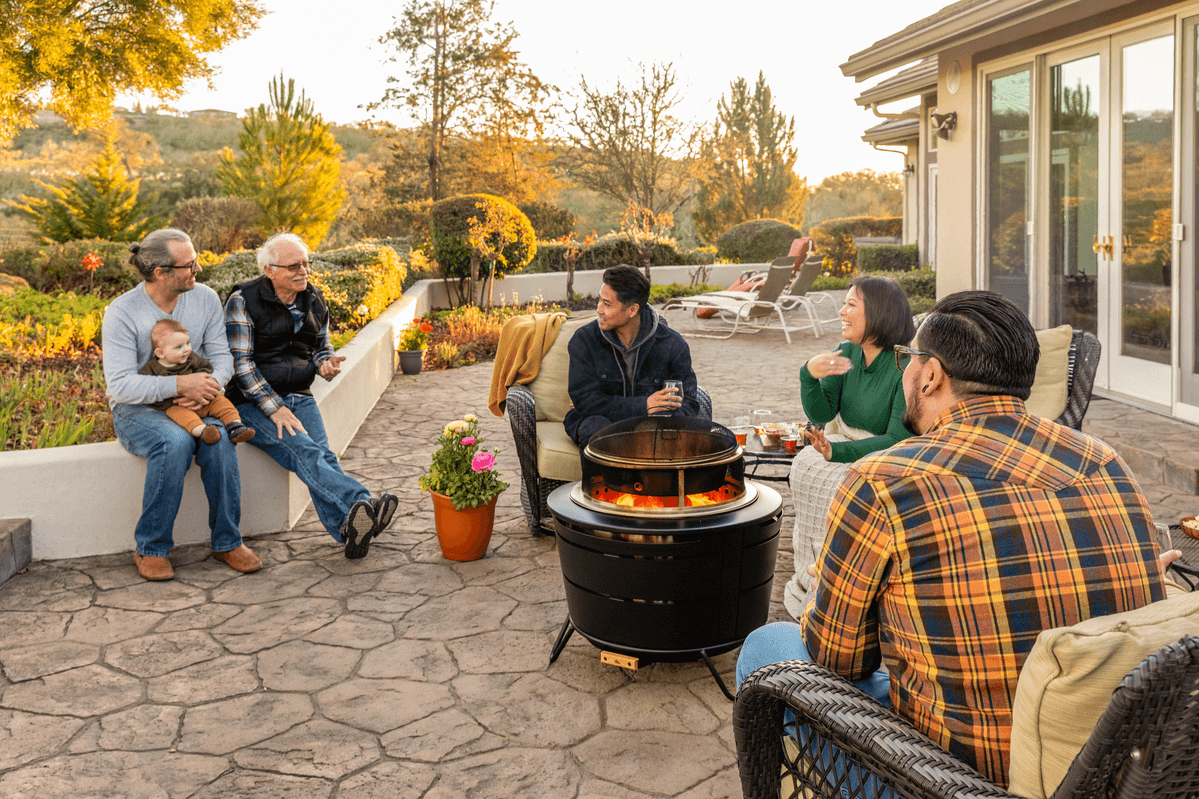 large group of friends gathered around a smokeless fire pit