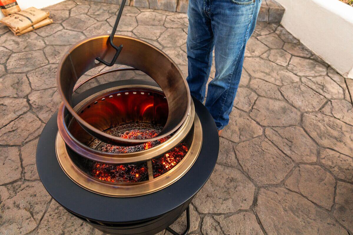 close up of the reunion smokeless fire pit with a heat deflector and screen